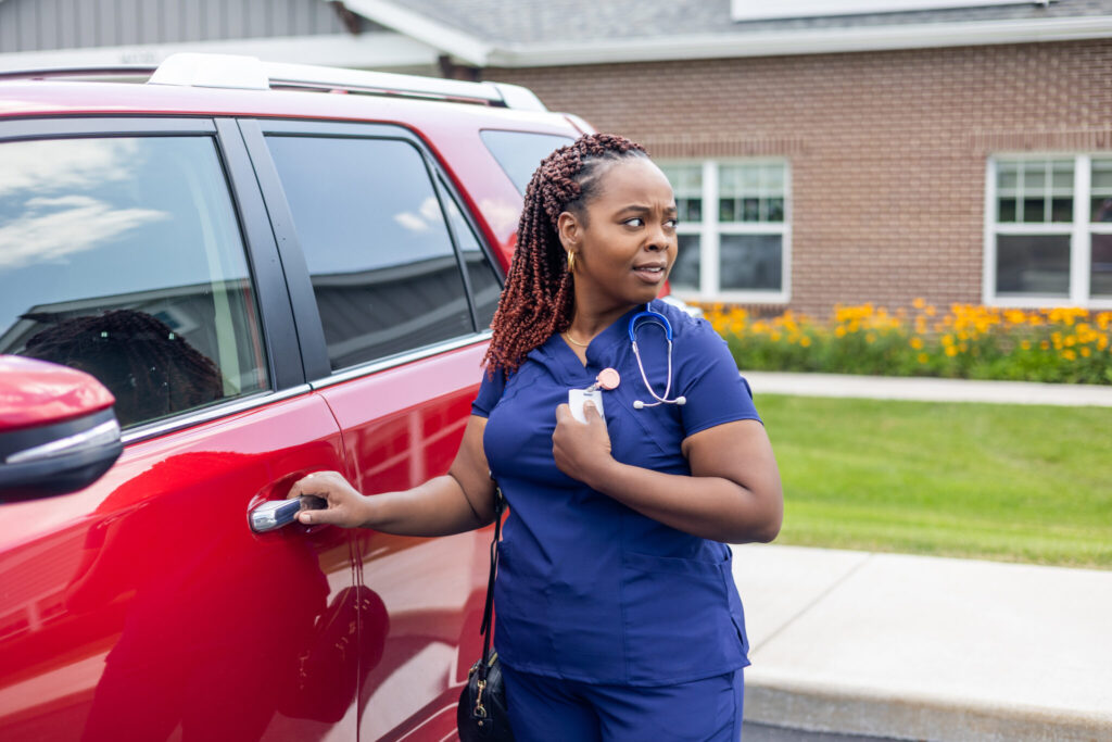 Nurse in parking lot pushing panic button
